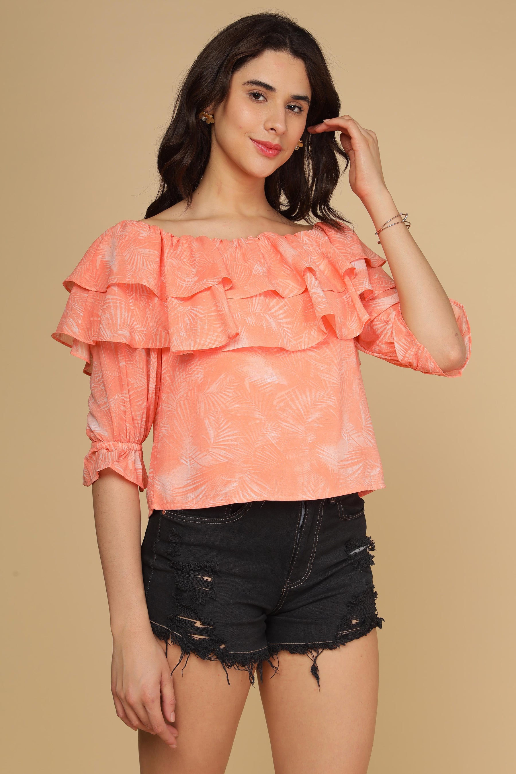 Stylish peach printed top with ruffles, perfect for summer outings.
