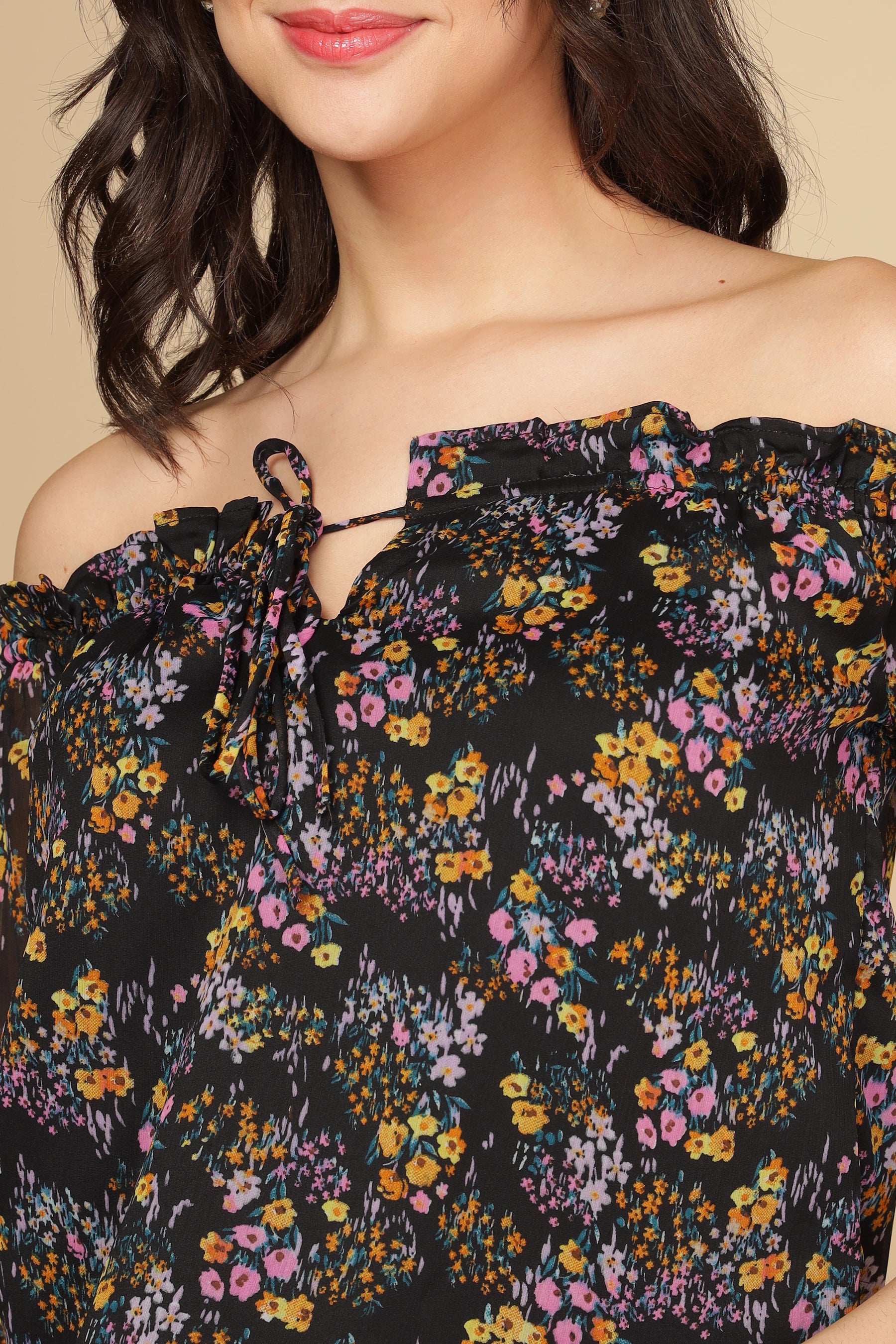 Off-the-shoulder multi floral top with colorful print and tie detail.
