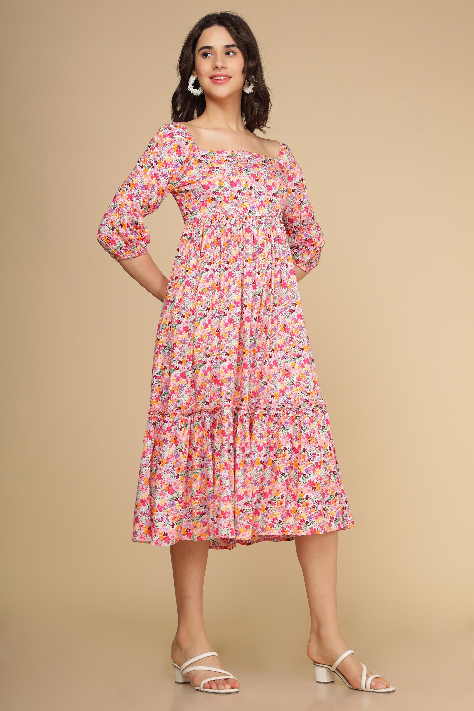 White floral cotton maxi dress with puff sleeves and tiered skirt.