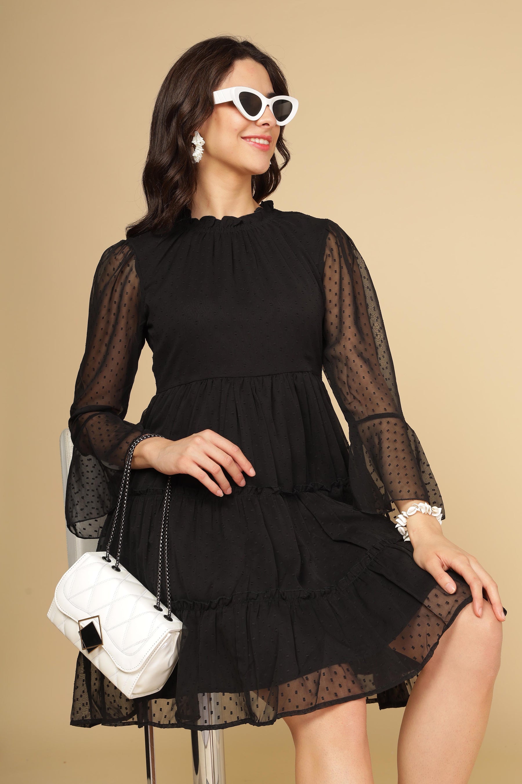 Chic little black chiffon midi dress with stylish accessories.