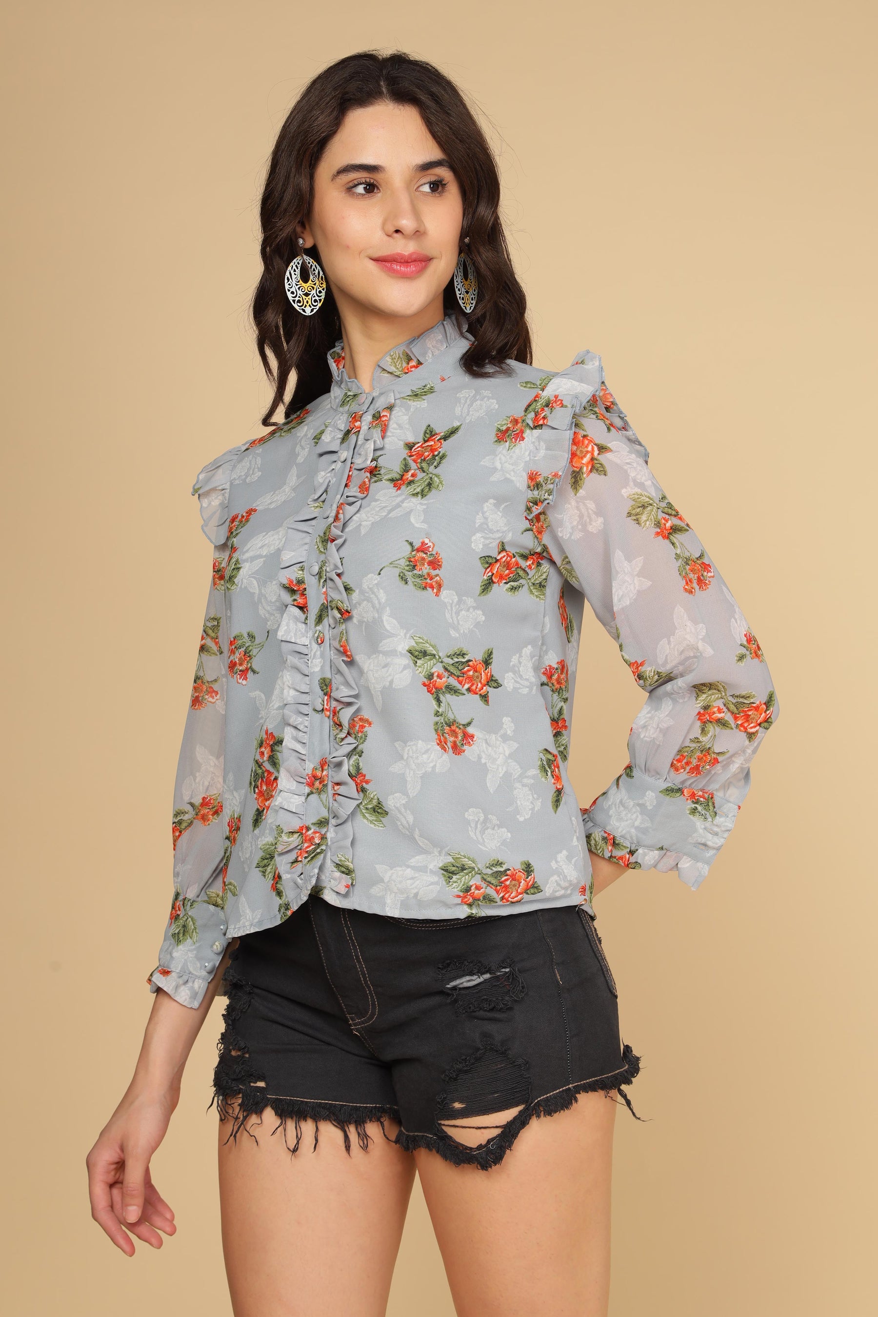 Pastel blue ruffle shirt top with floral design and stylish sleeves.