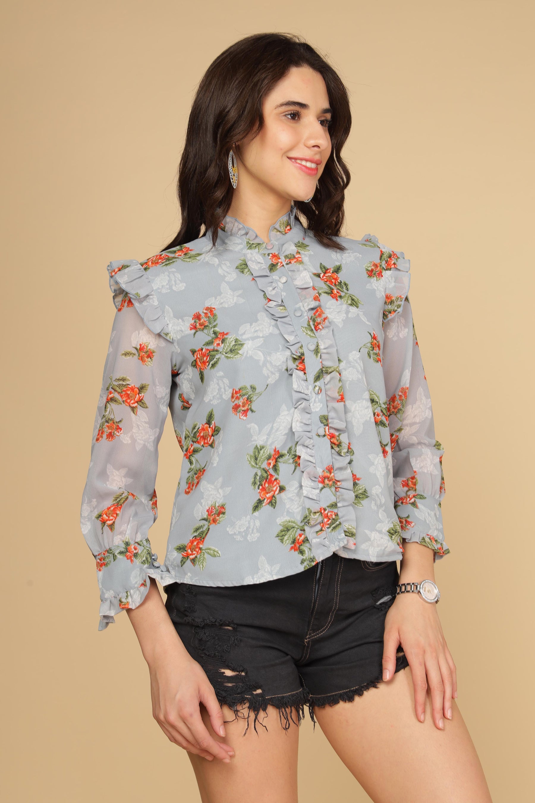 Pastel blue ruffle shirt top with floral print and stylish design.
