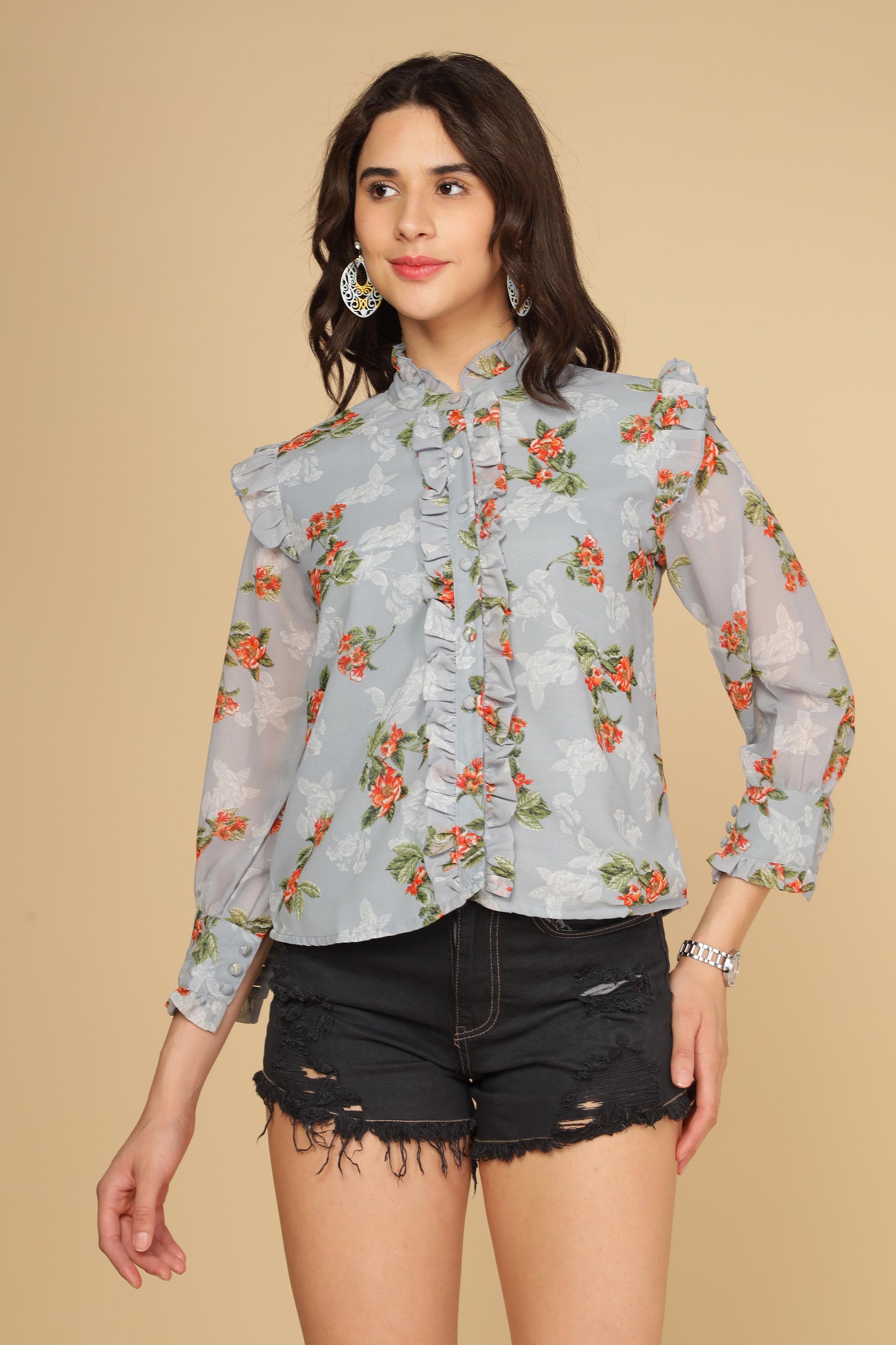 Pastel blue ruffle shirt top with floral design and stylish sleeves.