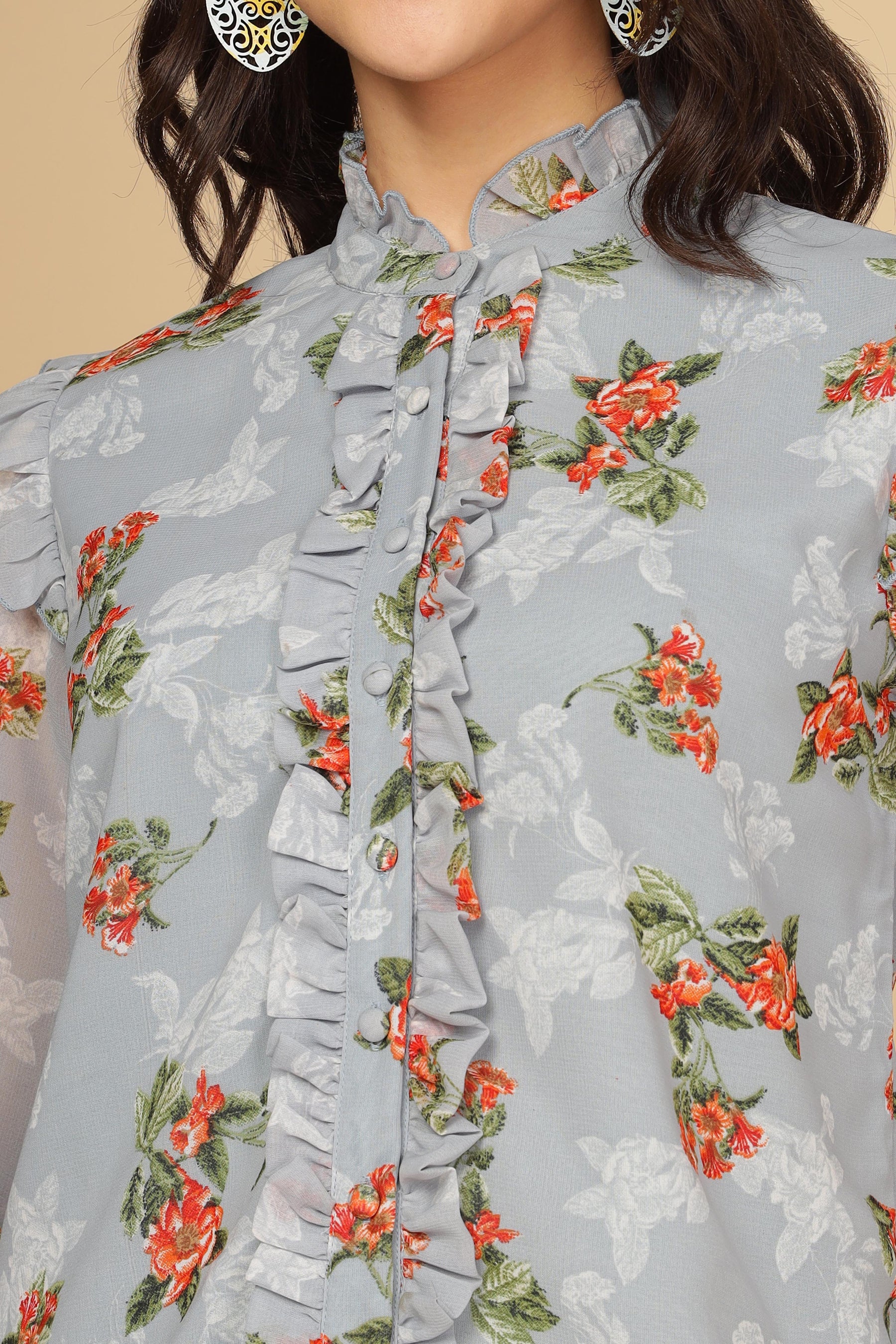Pastel blue ruffle shirt top with floral design and buttons.