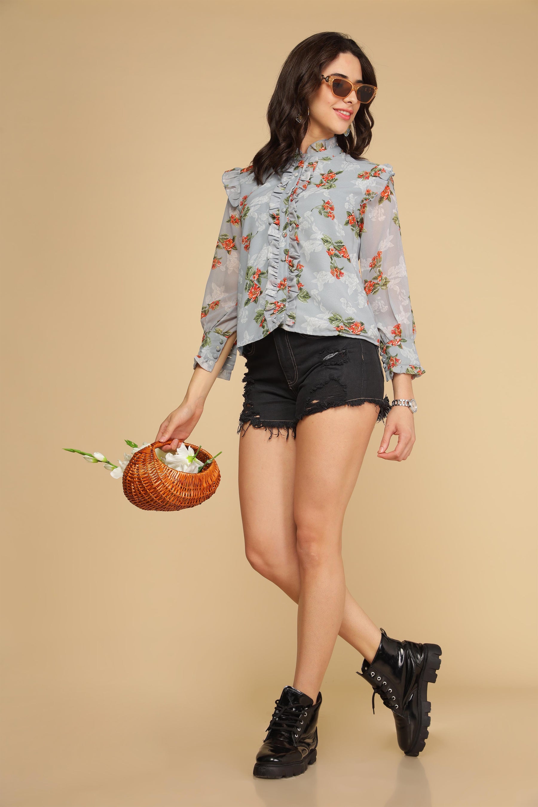 Pastel blue ruffle shirt top with floral design and stylish shorts.