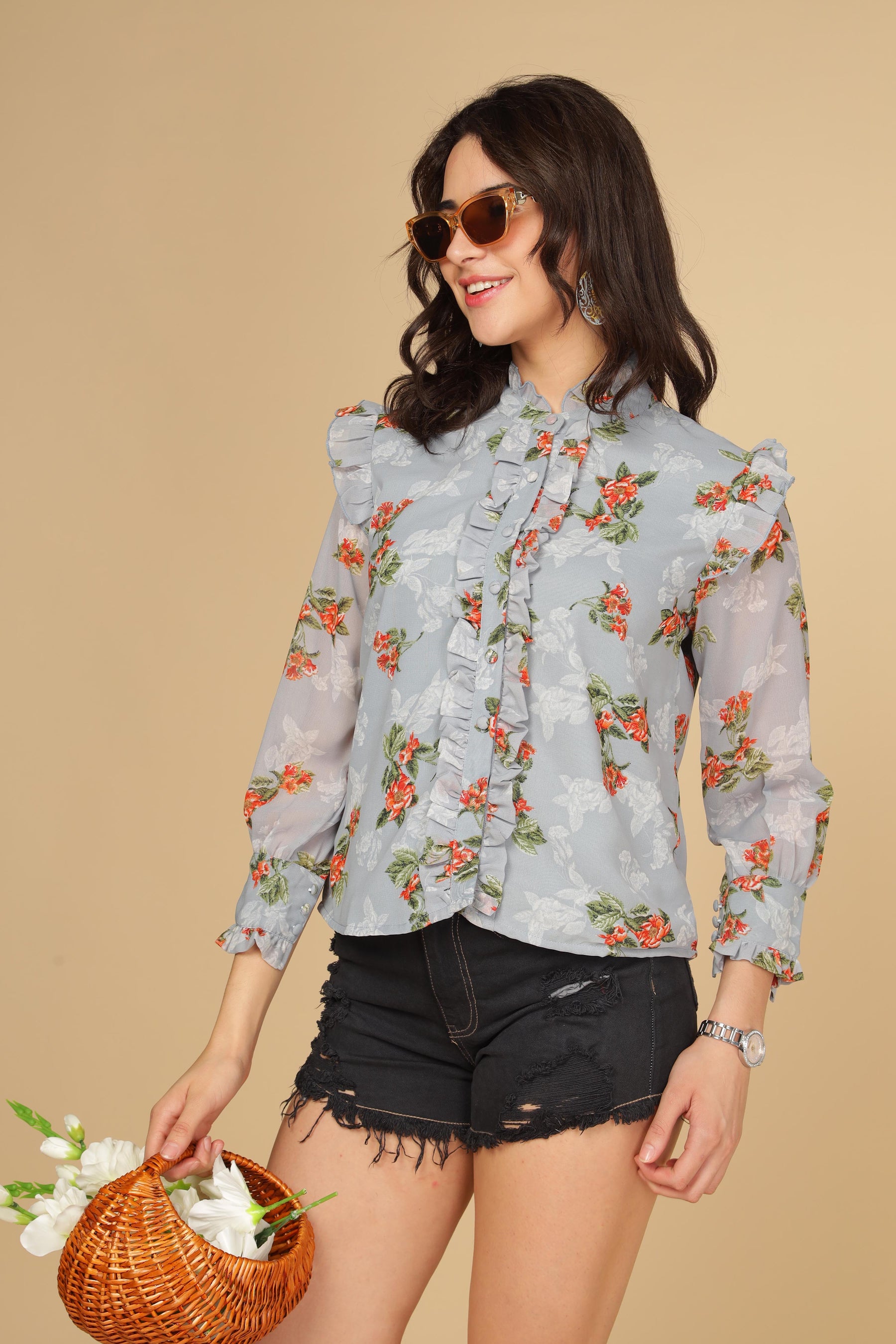 Pastel blue ruffle shirt top with floral design and stylish model.