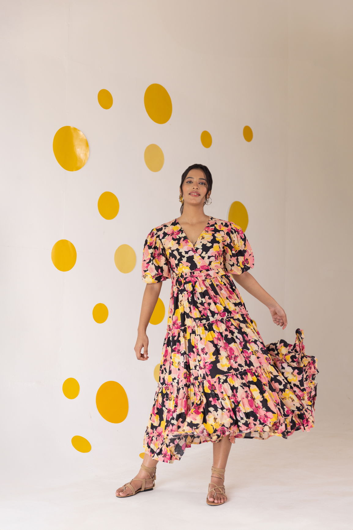 Model wearing a vibrant floral tiered cotton maxi dress.