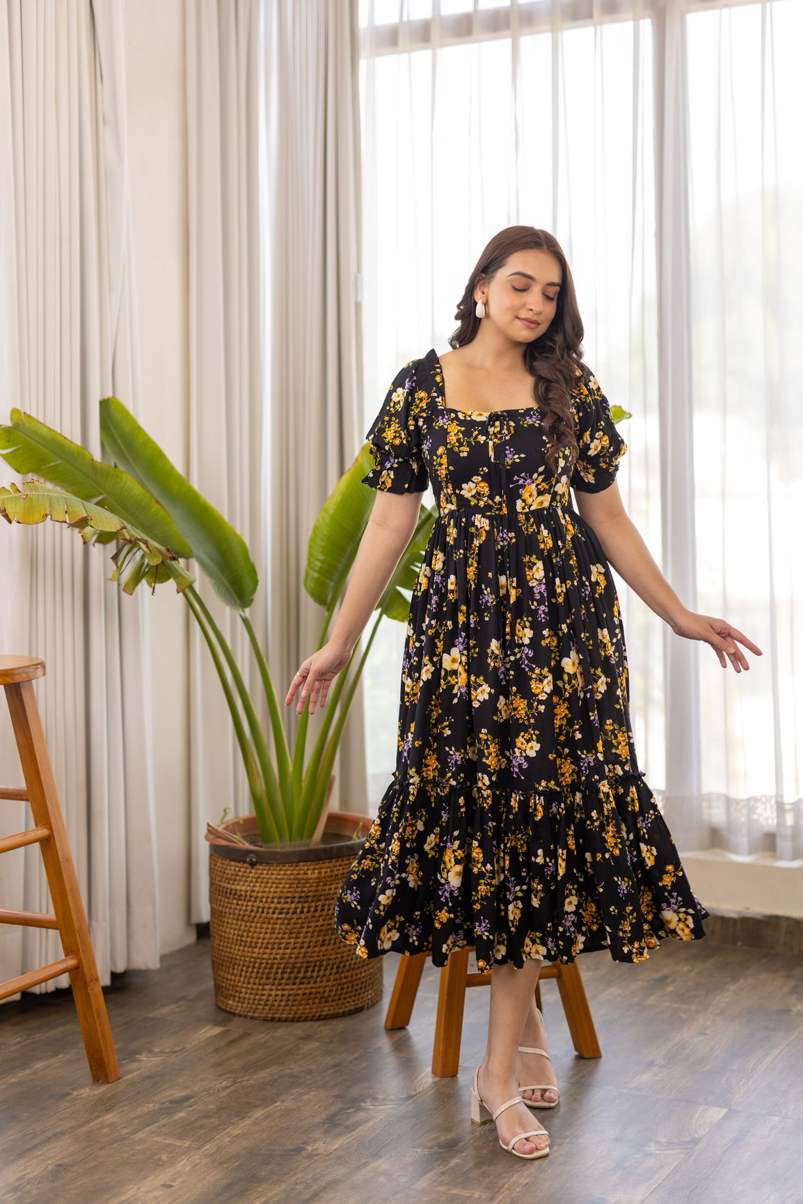 Black floral nursing maxi dress with puff sleeves and tiered skirt.