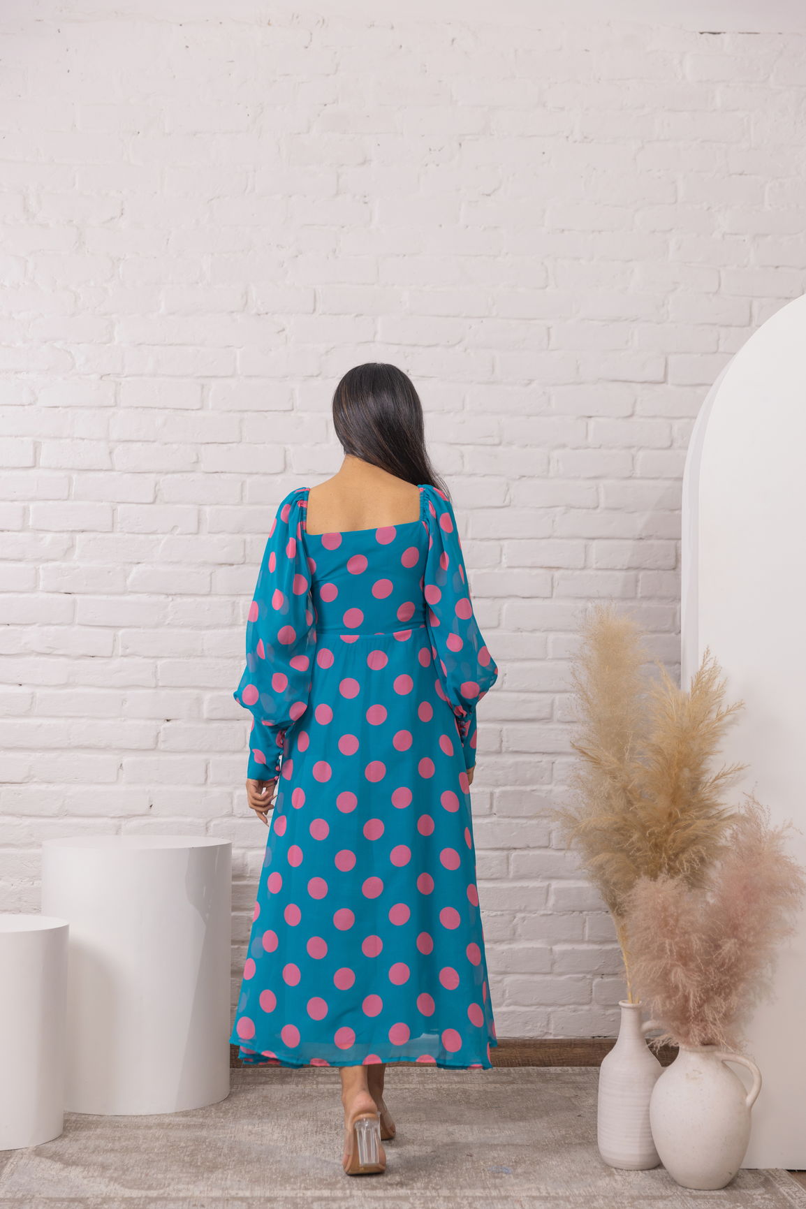 Stylish blue polka dot maxi dress with puff sleeves, perfect for summer.