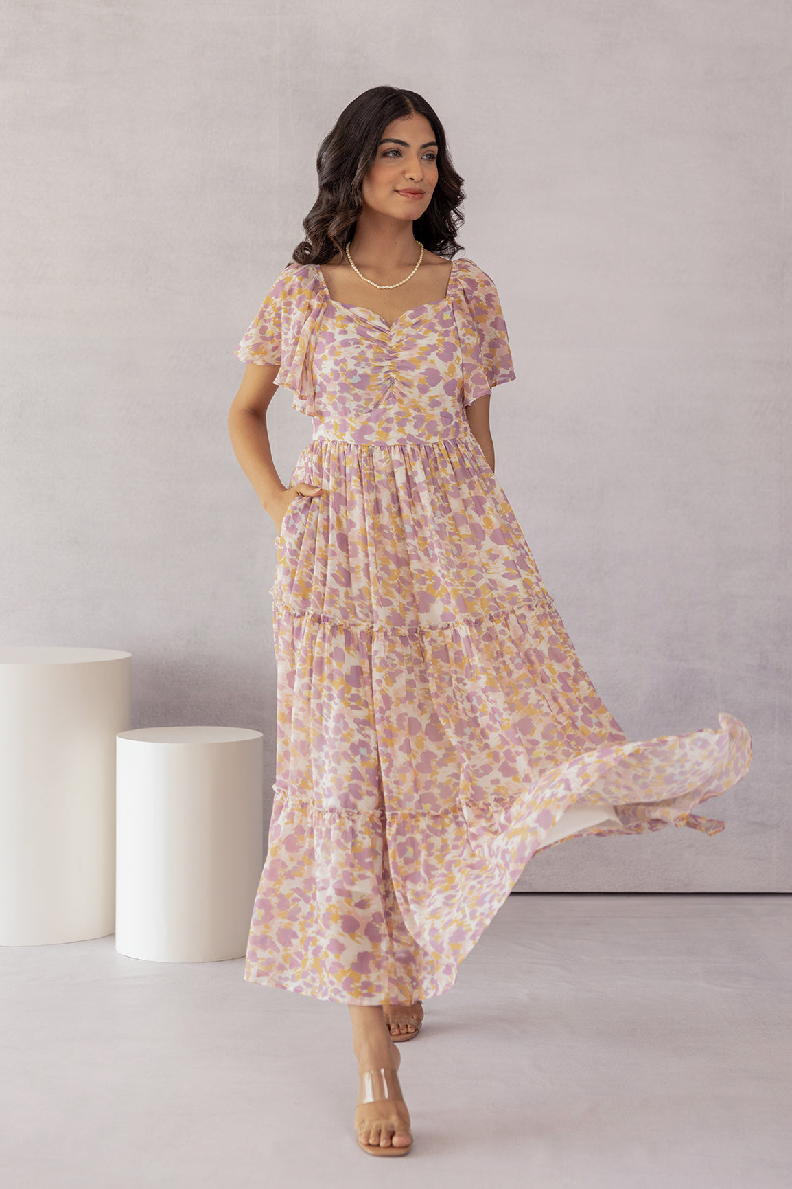 Mosaic print maxi dress with flutter sleeves and flowy design.