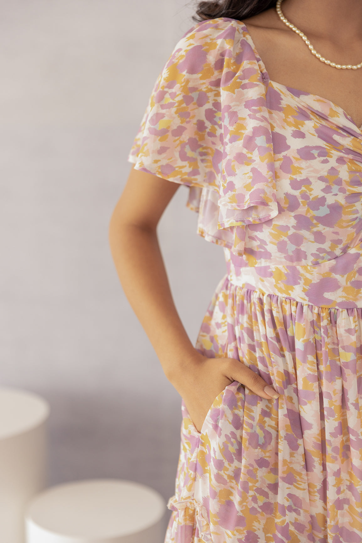 Model showcasing the MOSAIC PRINT MAXI dress with floral design.