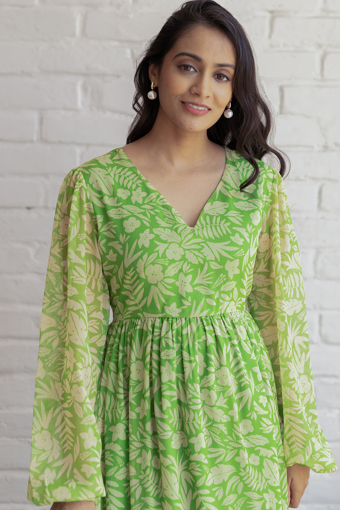 Green and yellow floral maxi dress with long sleeves.