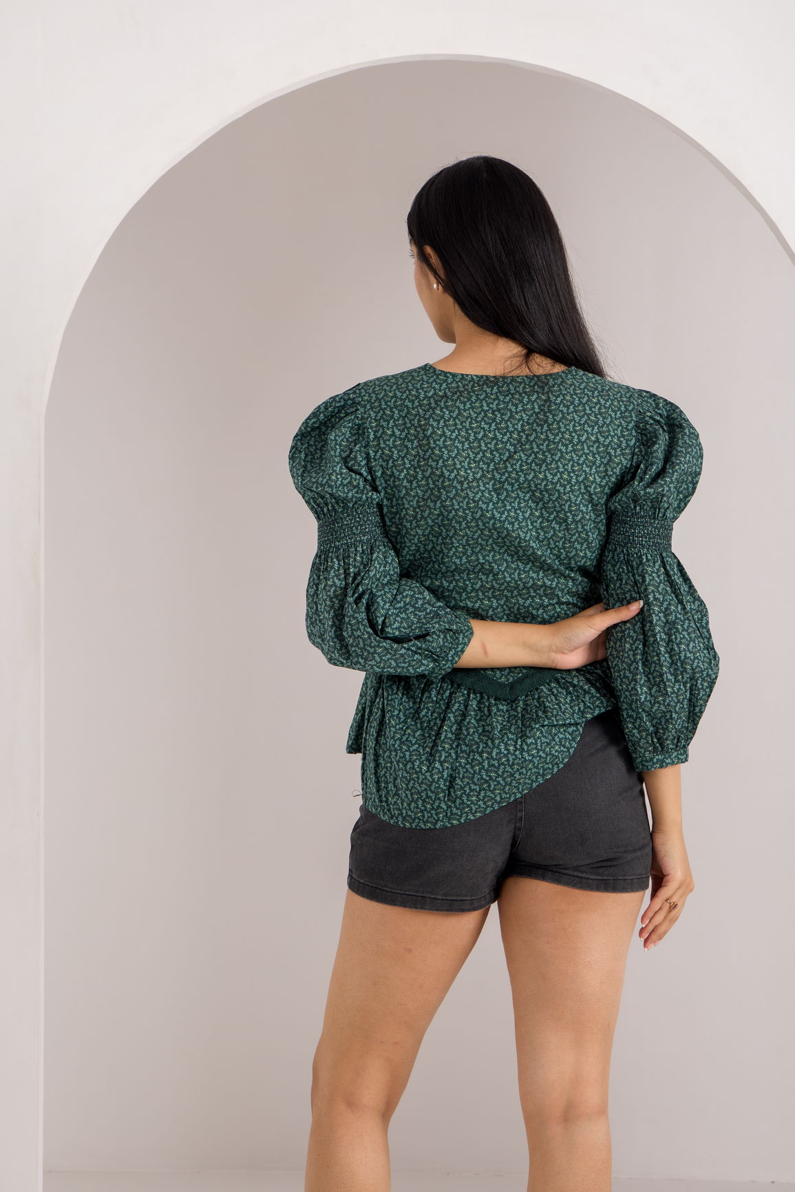 Emerald green cotton top with puffed sleeves and stylish design.