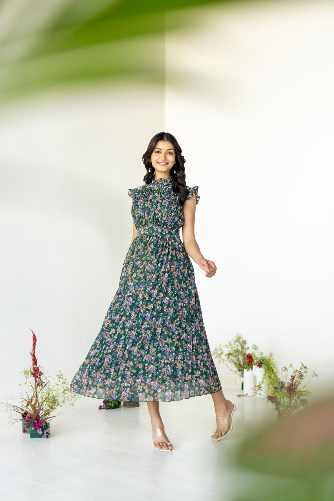Emerald pleated maxi dress with floral print and model.
