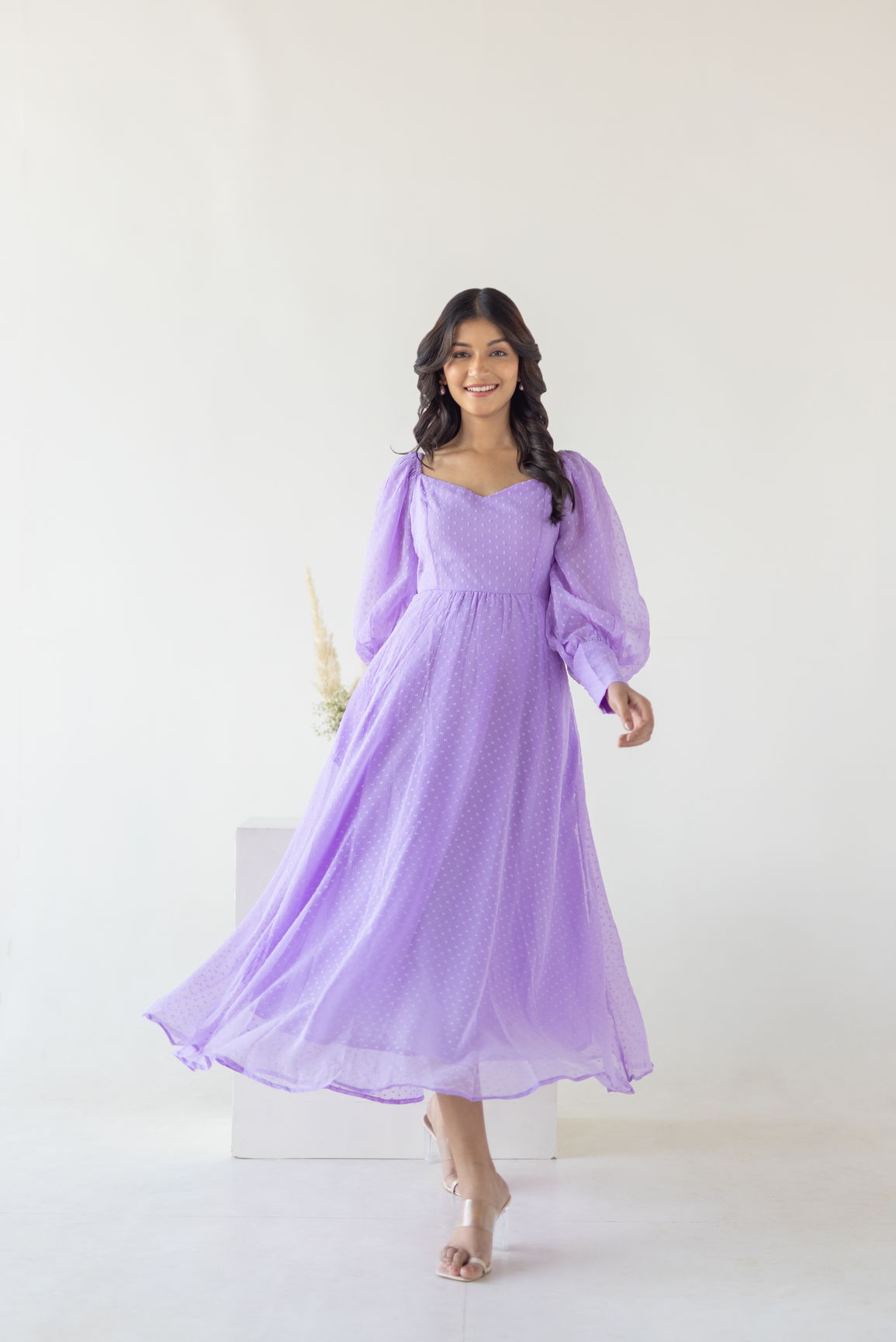 Lilac Princess Maxi dress model showcasing vibrant purple design and flowing silhouette.