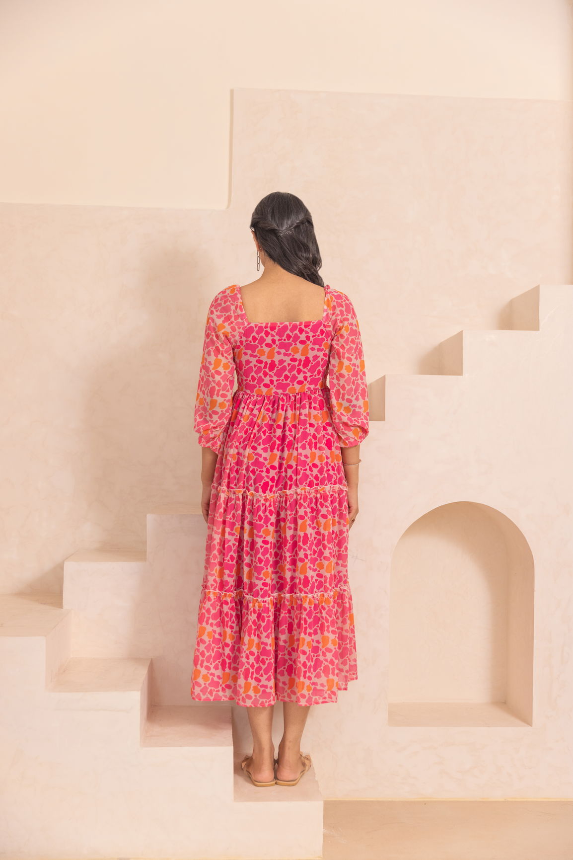 Mosaic print maxi dress in vibrant pink and orange colors.