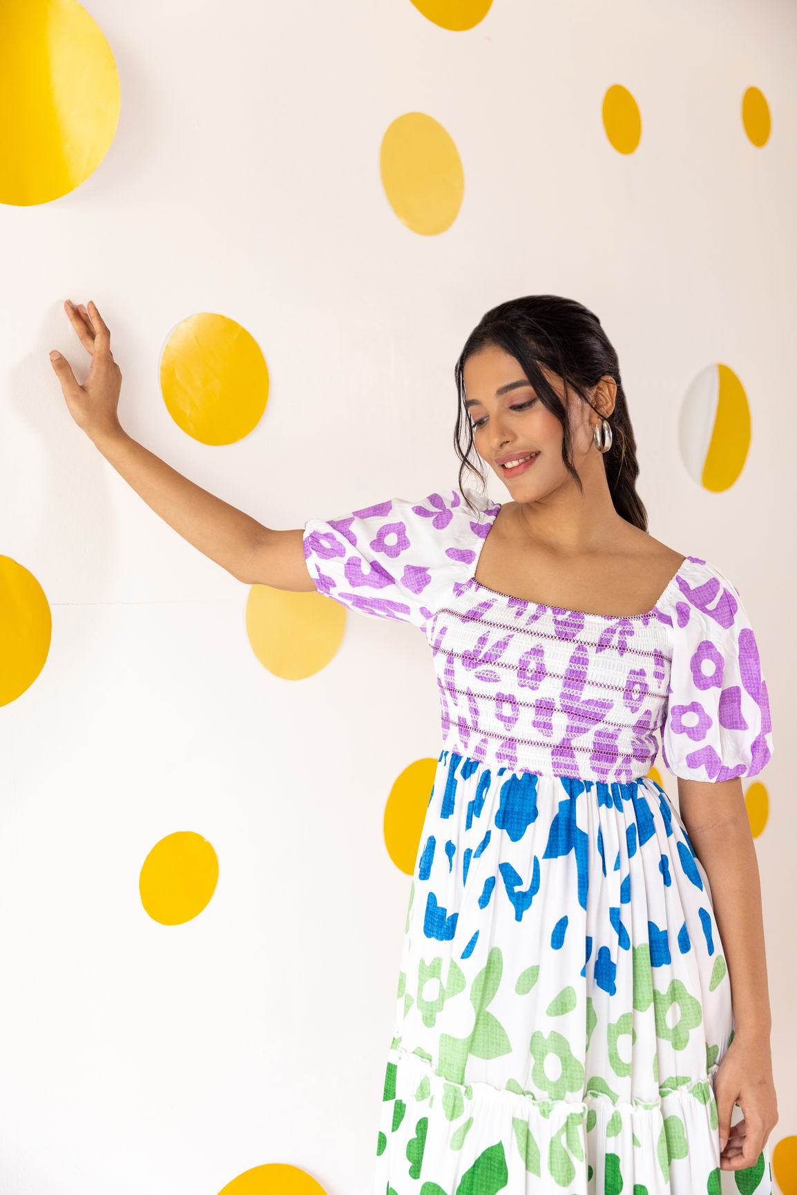 Multicolour smocked maxi dress against a vibrant yellow backdrop.