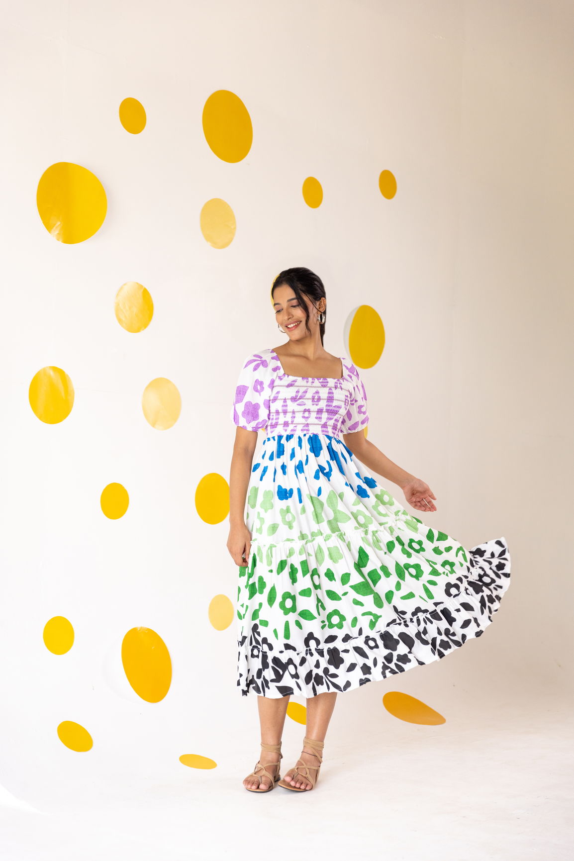 Multicolour smocked maxi dress on a model with yellow polka dots background.
