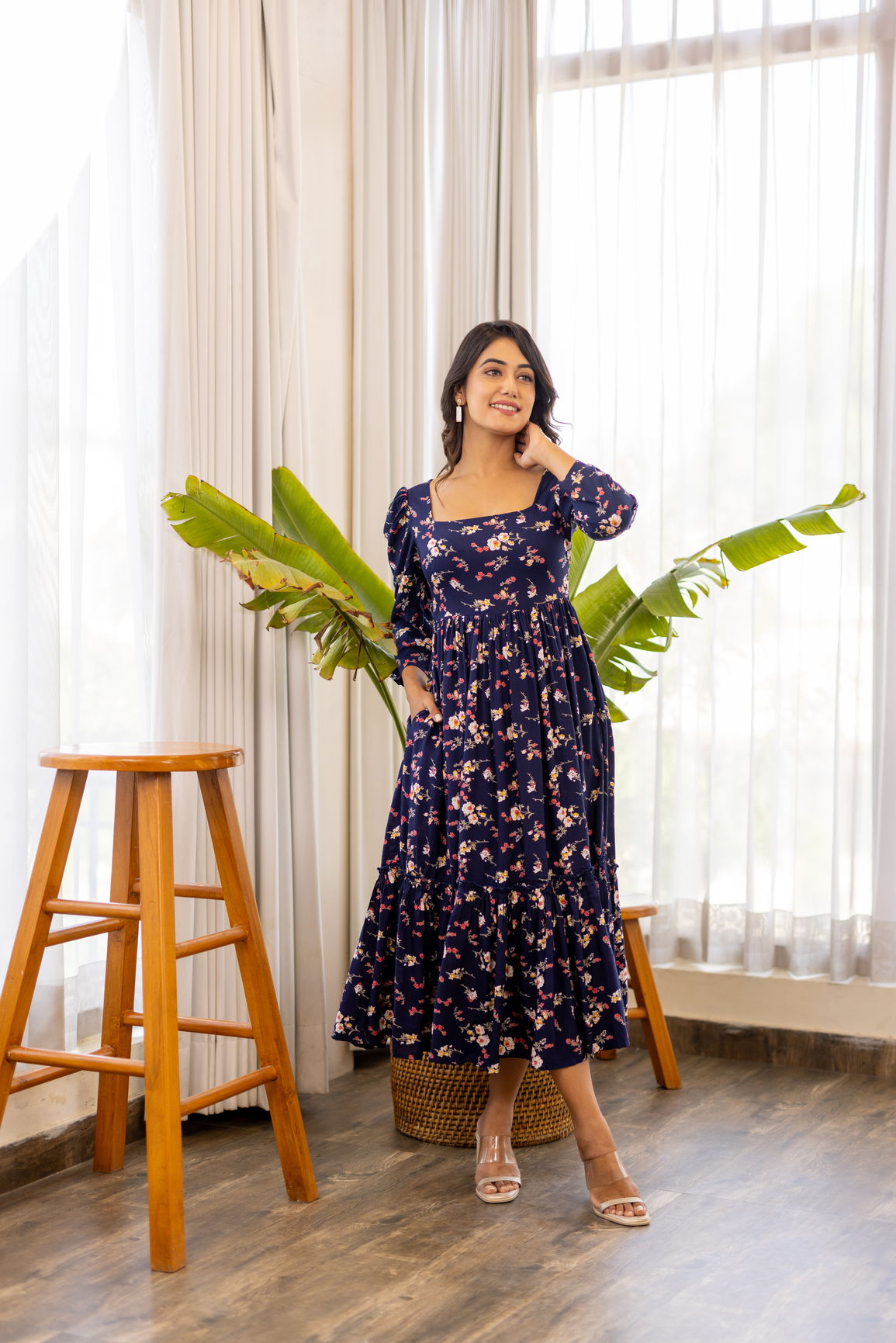 Navy blue floral maxi dress displayed indoors with natural lighting.
