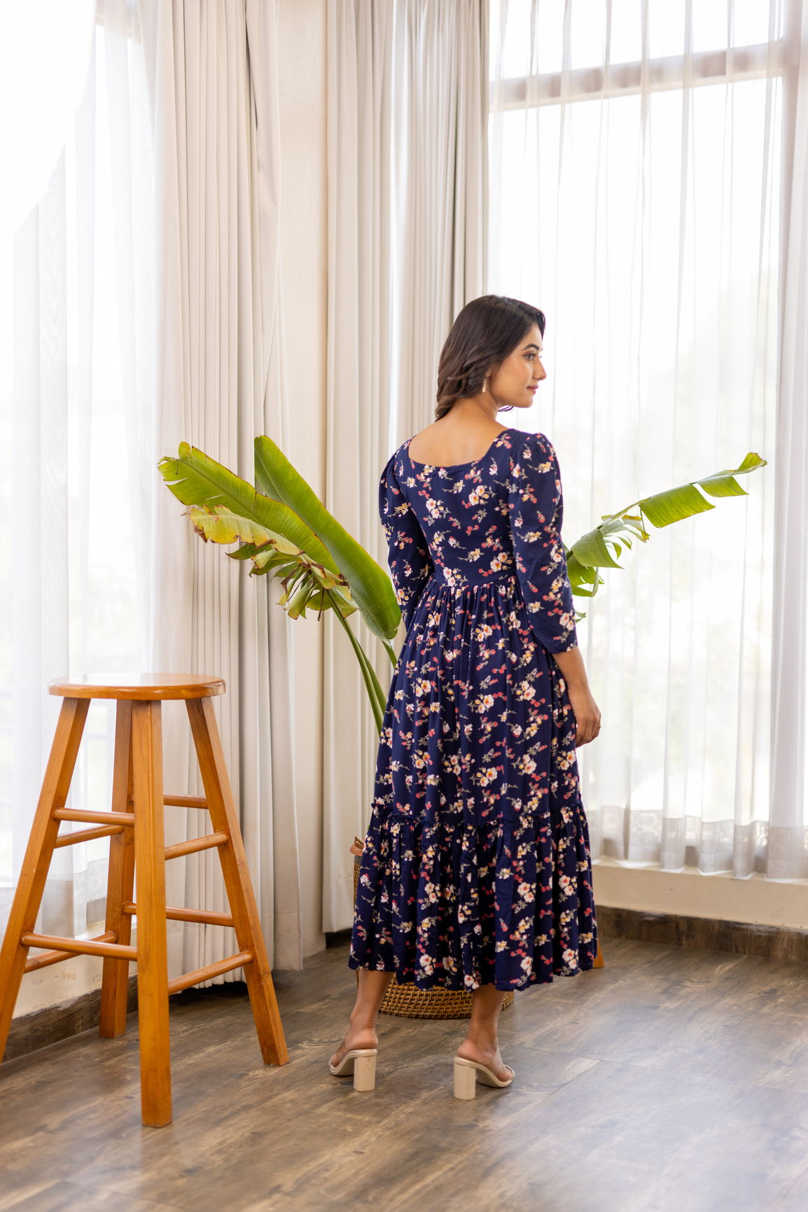 Navy blue floral maxi dress with 3/4 sleeves and tiered hem.