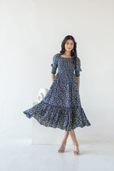 Navy mosaic cotton maxi dress modeled by a woman.