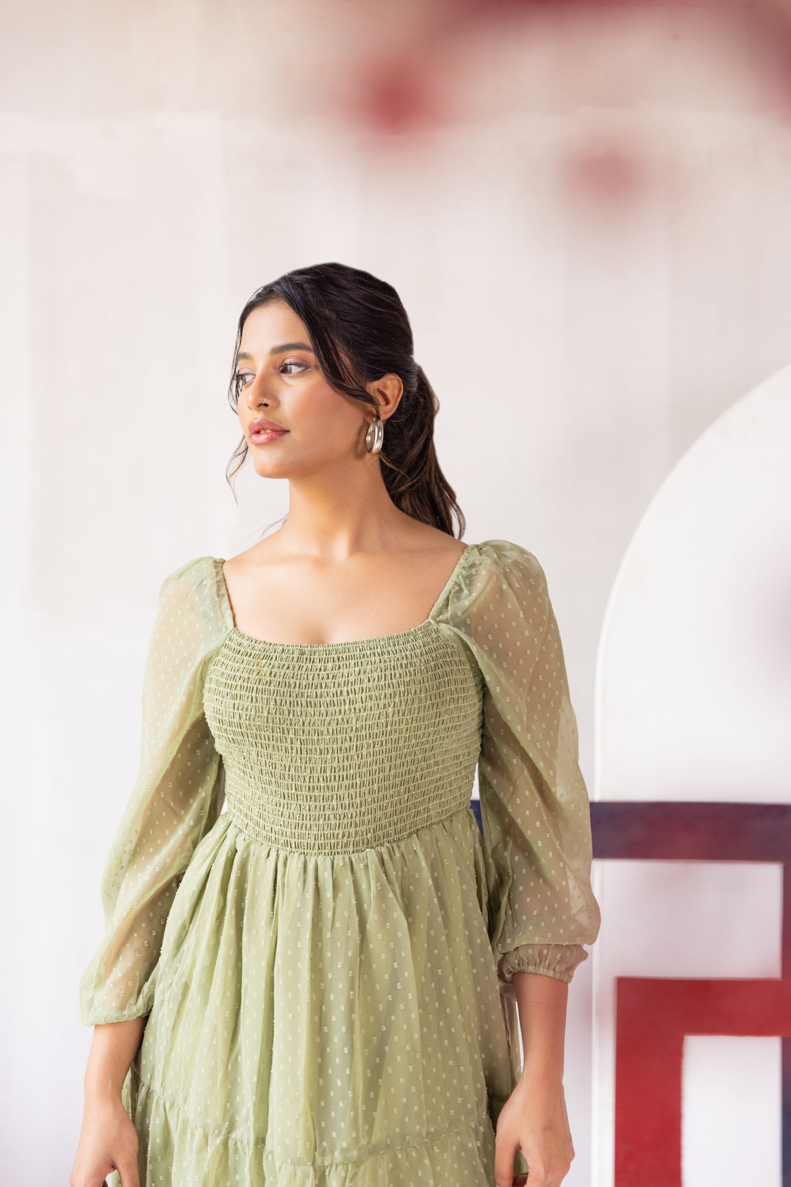 Pastel green smocked maxi dress with elegant puff sleeves.