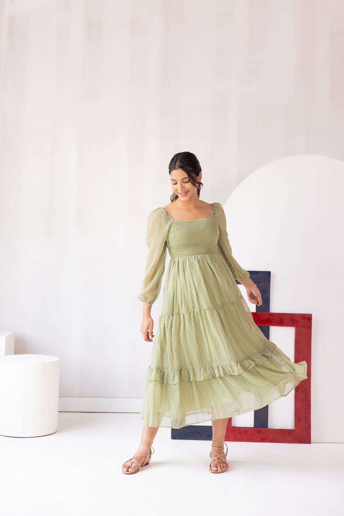 Pastel green smocked maxi dress with puffed sleeves and ruffle hem.