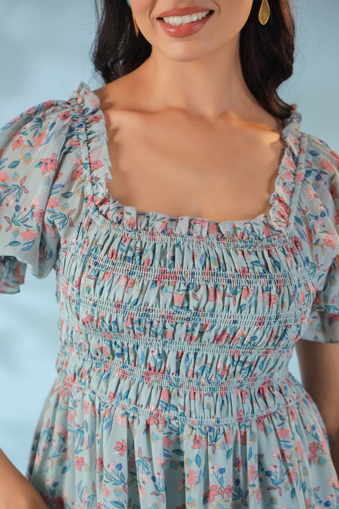 Pastel smocked nursing maxi dress with floral design and ruffled sleeves.