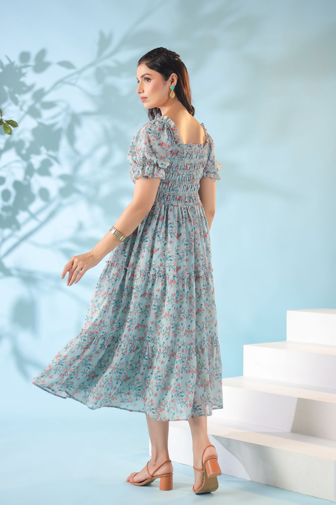 Pastel smocked nursing maxi dress with floral print and flowing silhouette.