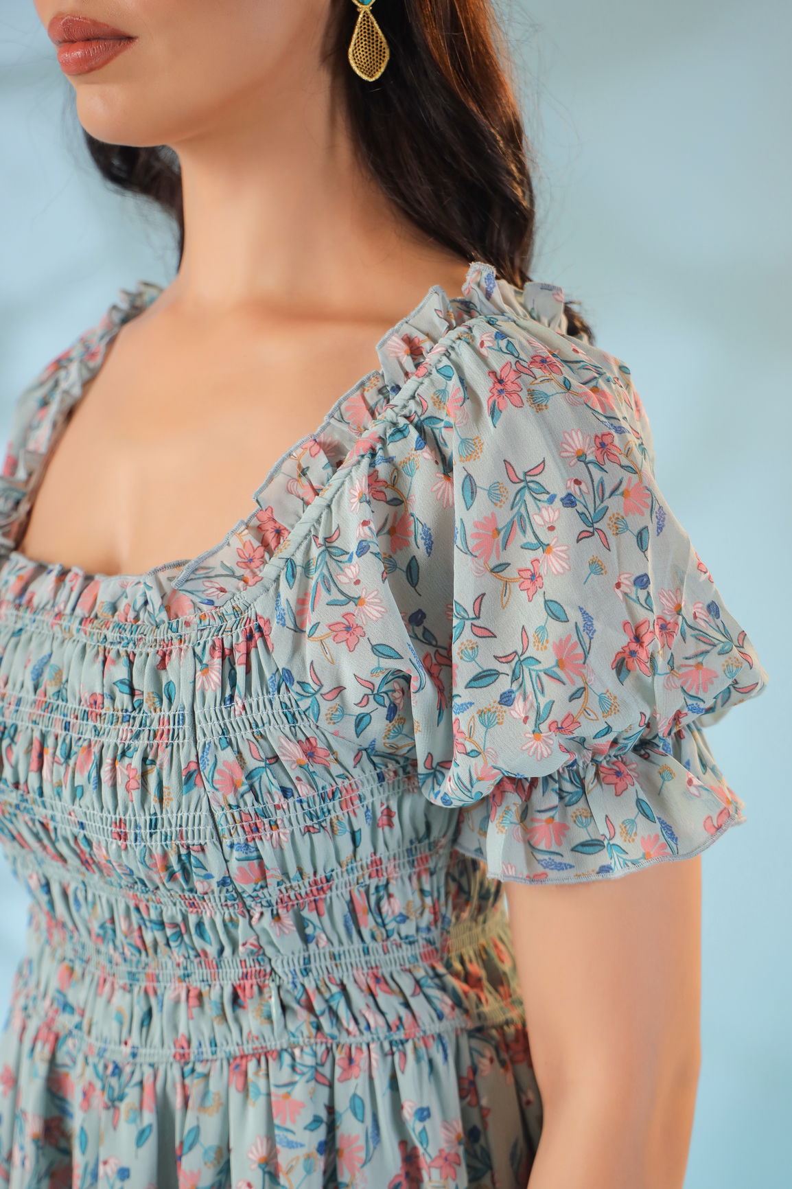 Pastel smocked nursing maxi dress with floral design and puff sleeves.