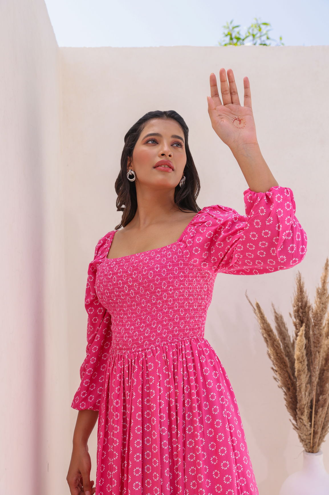 Model showcasing the PINK BUTTA COTTON MAXI dress in a bright setting.