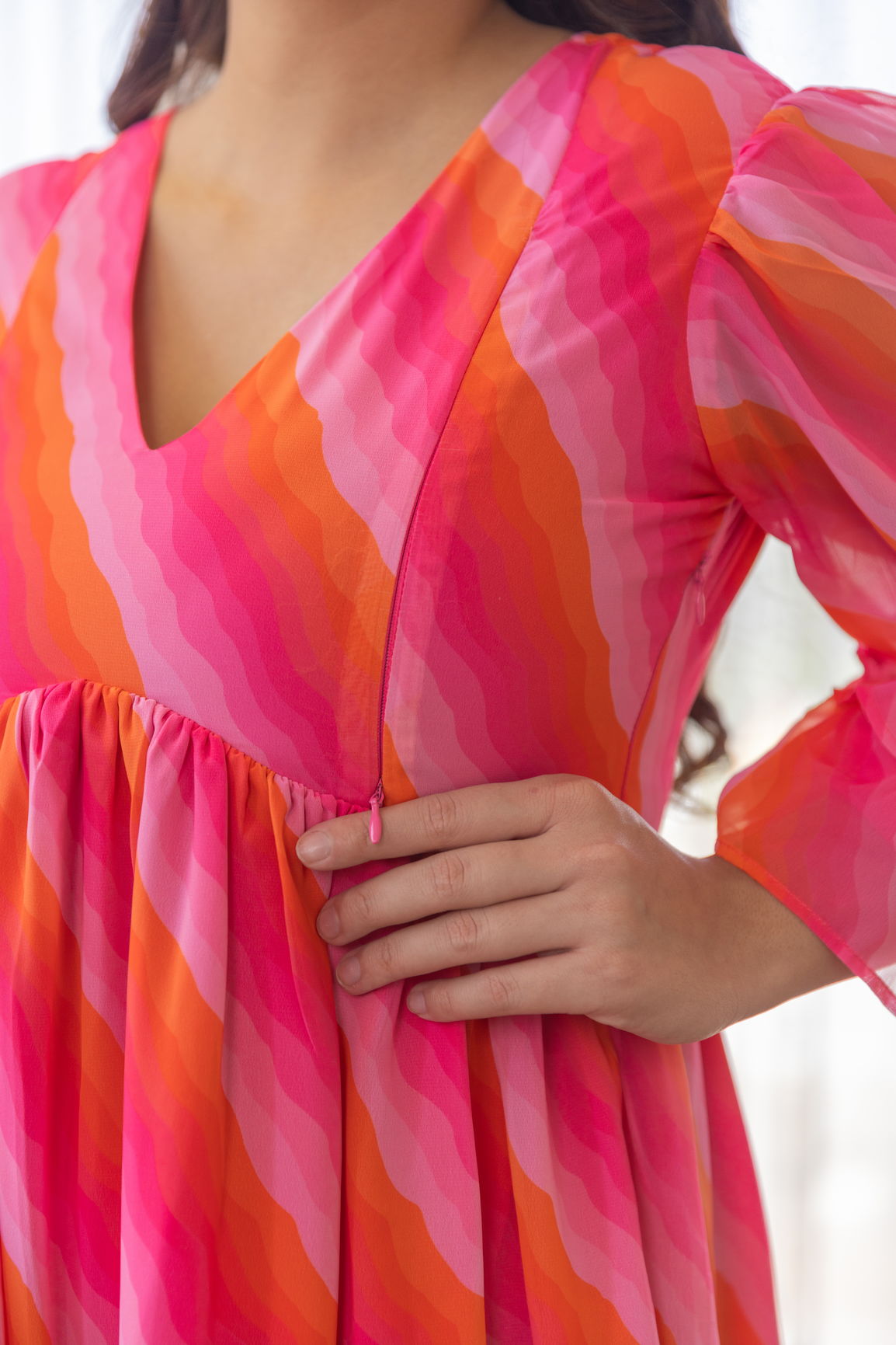 Vibrant pink and orange nursing maxi dress with flowy sleeves.