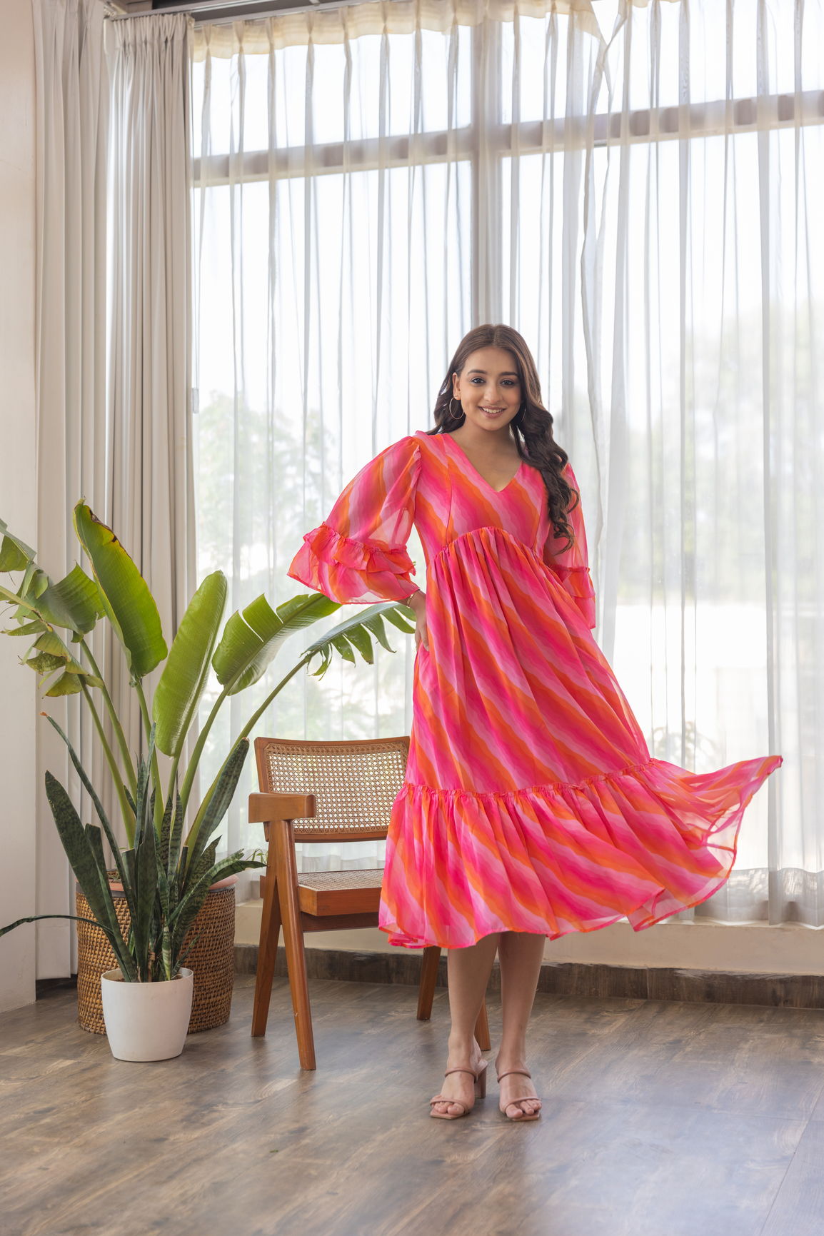 Stylish model in Pink Wave Nursing Maxi dress, showcasing vibrant colors.