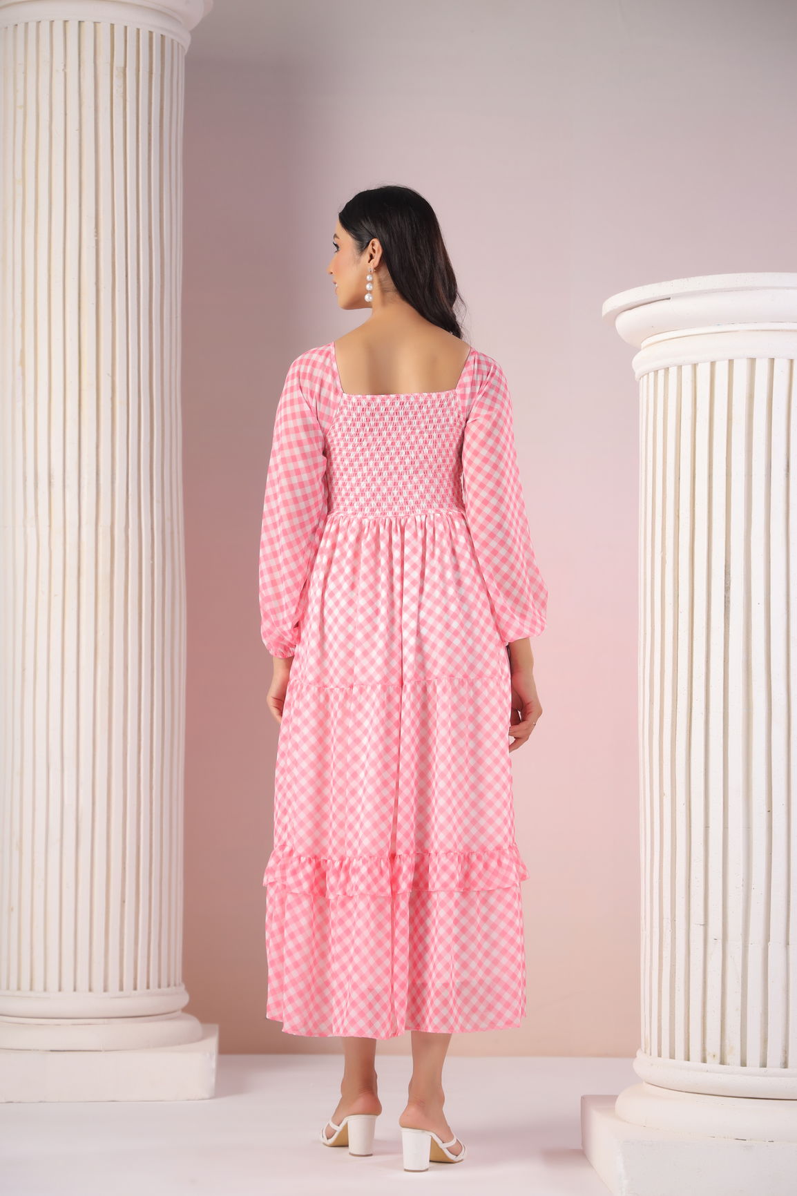 Back view of a pink gingham maxi dress with puff sleeves.