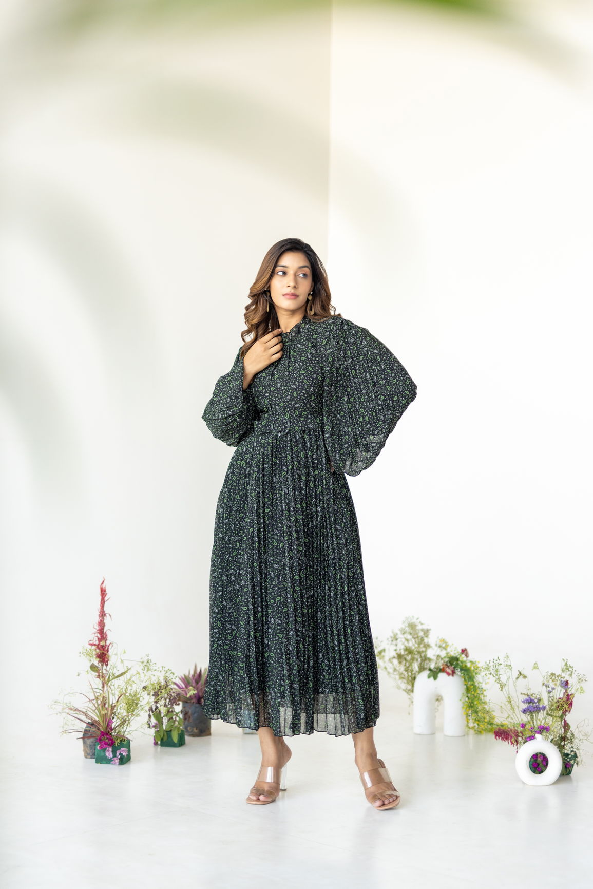 Elegant woman wearing Pleats on Pleats Maxi dress in floral print.