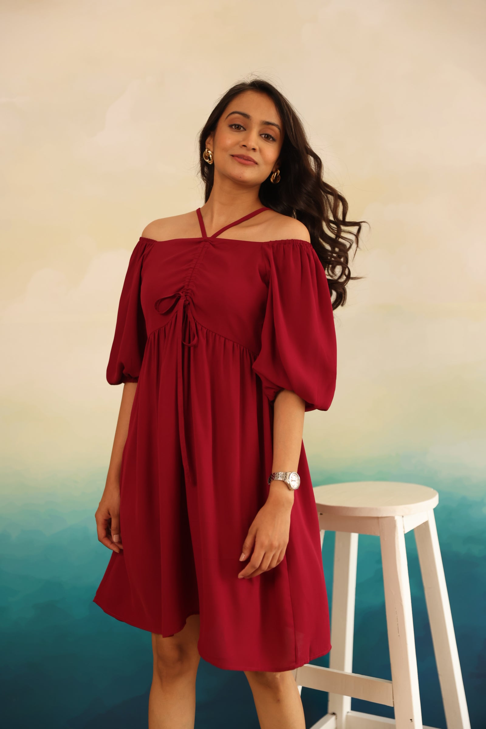 Burgundy midi dress with off-shoulder design and puff sleeves.