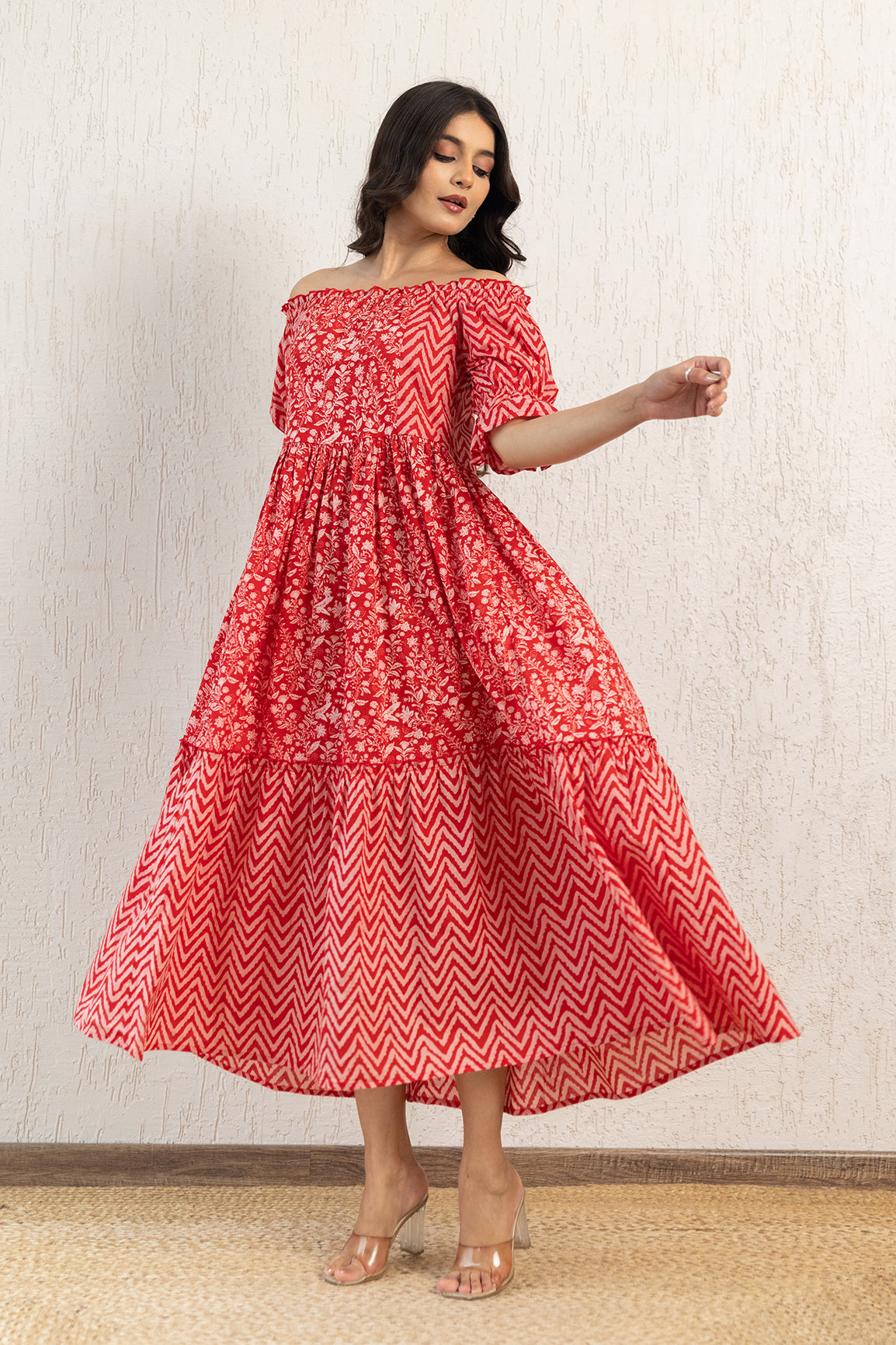 Red off-shoulder cotton maxi dress with floral and zigzag patterns.