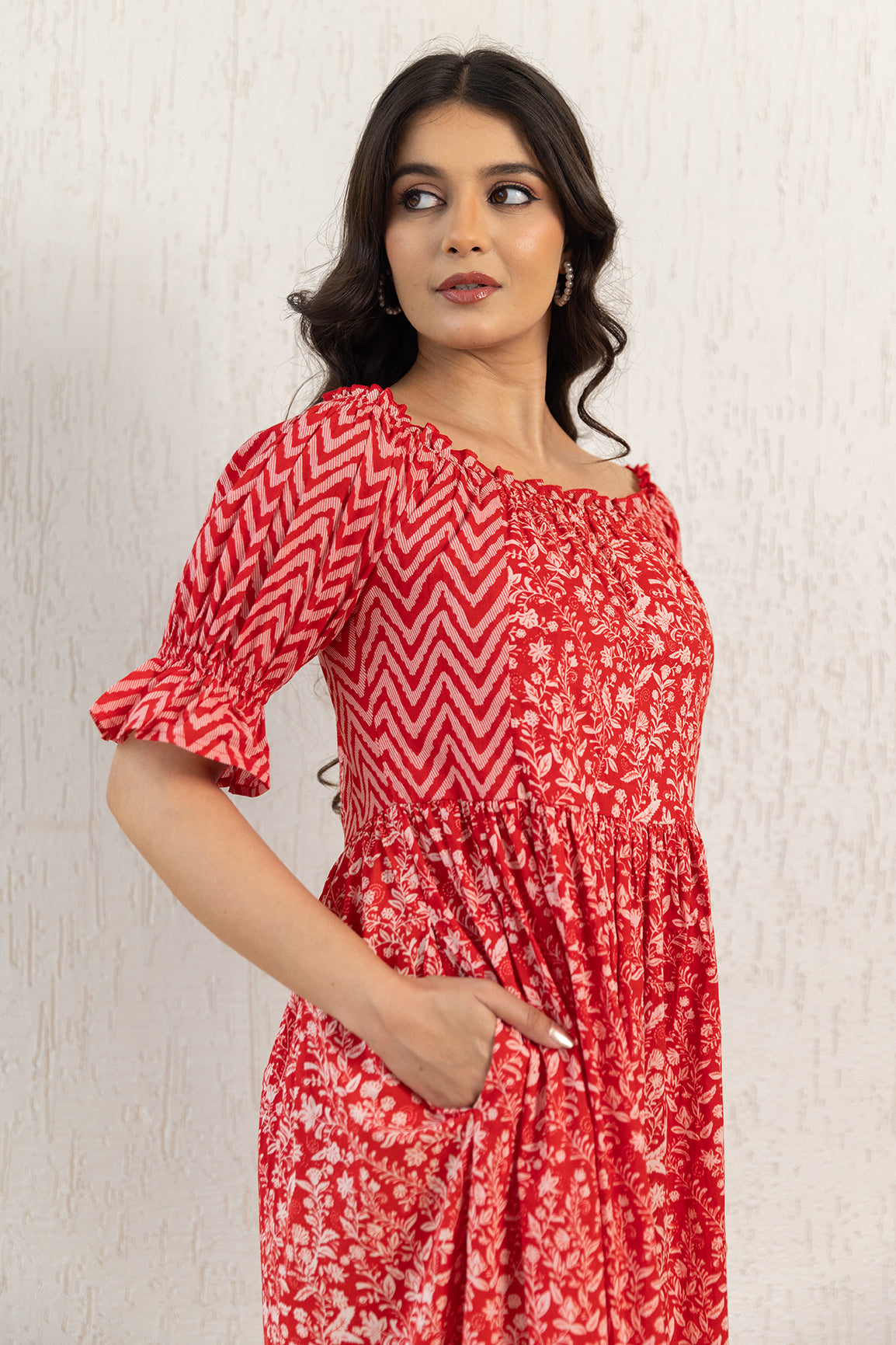 Stylish woman wearing a red off-shoulder cotton maxi dress.