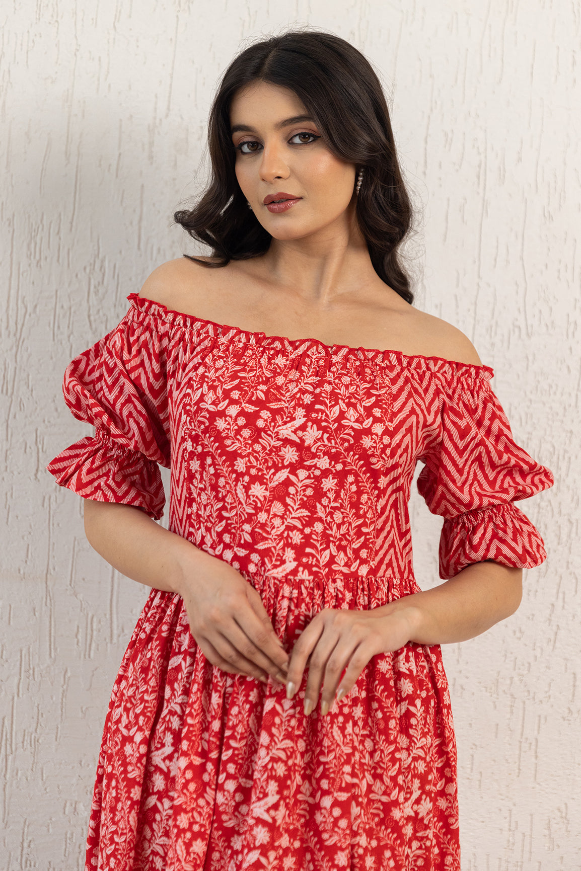 Red off-shoulder cotton maxi dress with floral design and puff sleeves.
