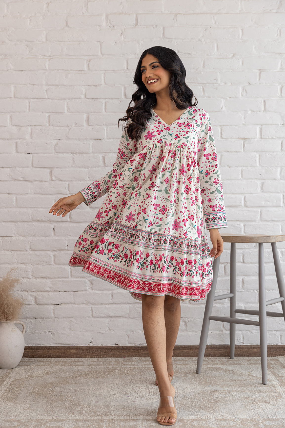 Floral cotton midi dress with long sleeves and playful design.
