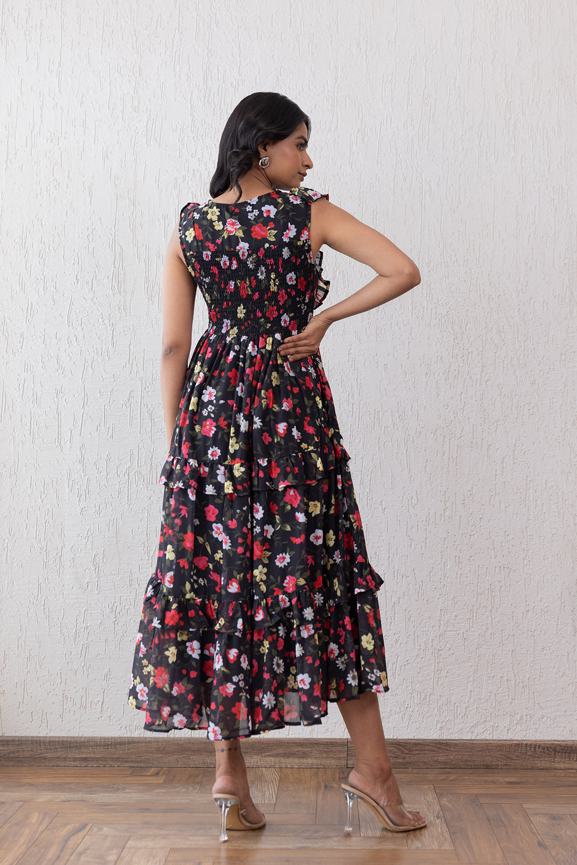 Black floral smocked maxi dress with tiered ruffles for women.