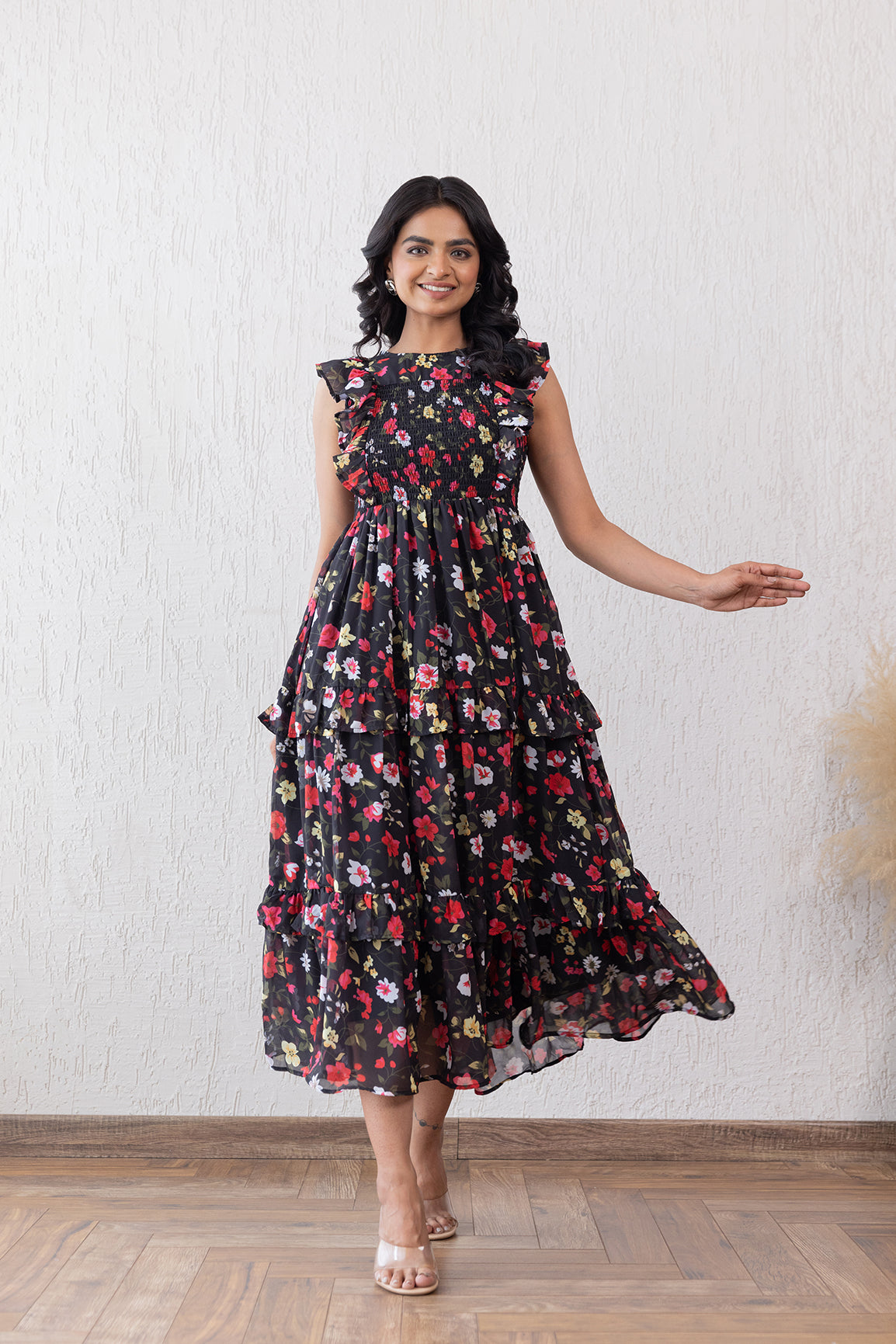 Black floral smocked maxi dress with ruffled sleeves for women.
