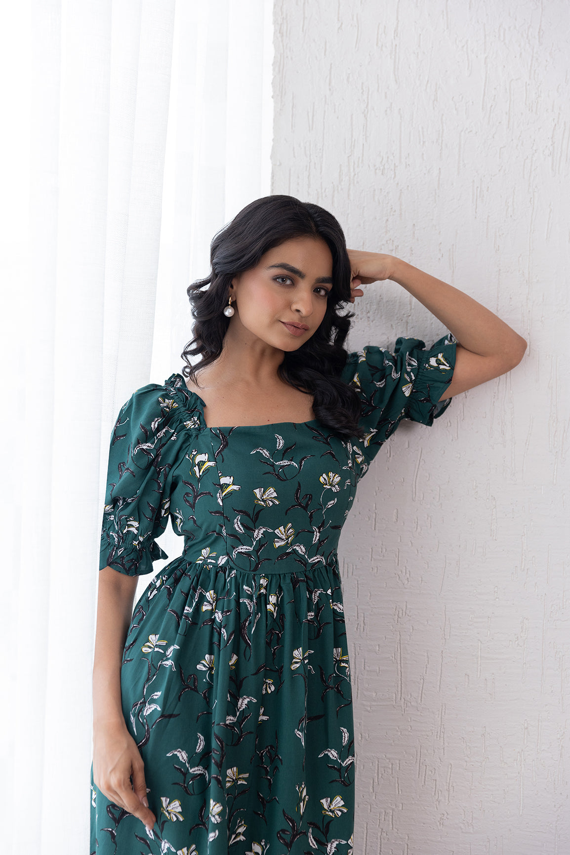 Stylish woman wearing a green cotton nursing maxi dress.