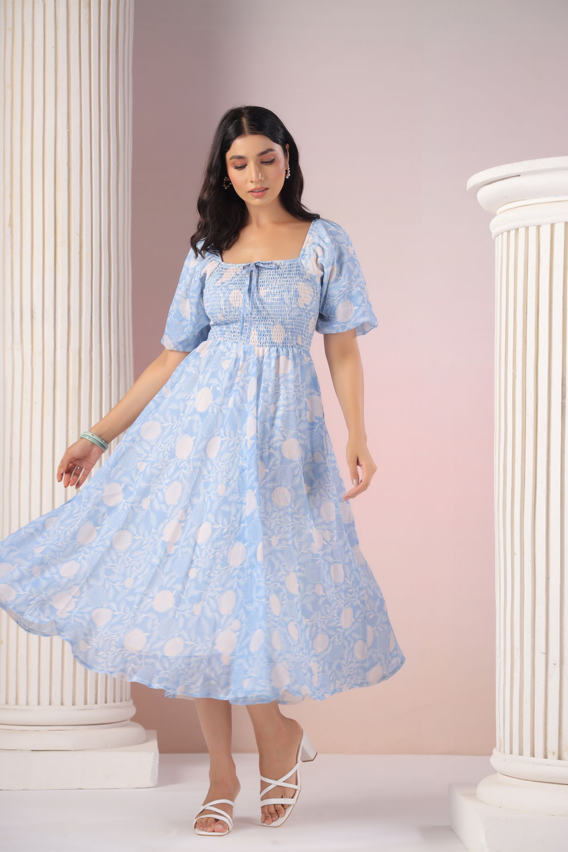 Sky blue and cream floral maxi dress on a model.