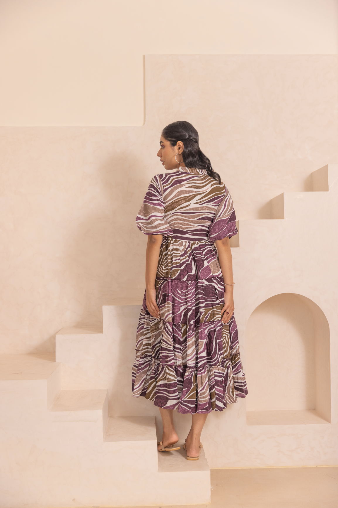 Stylish woman in WAVE MAXI dress on stairs.