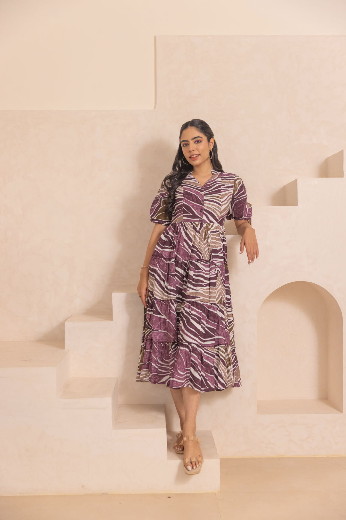 Stylish woman in WAVE MAXI dress on elegant stairs.