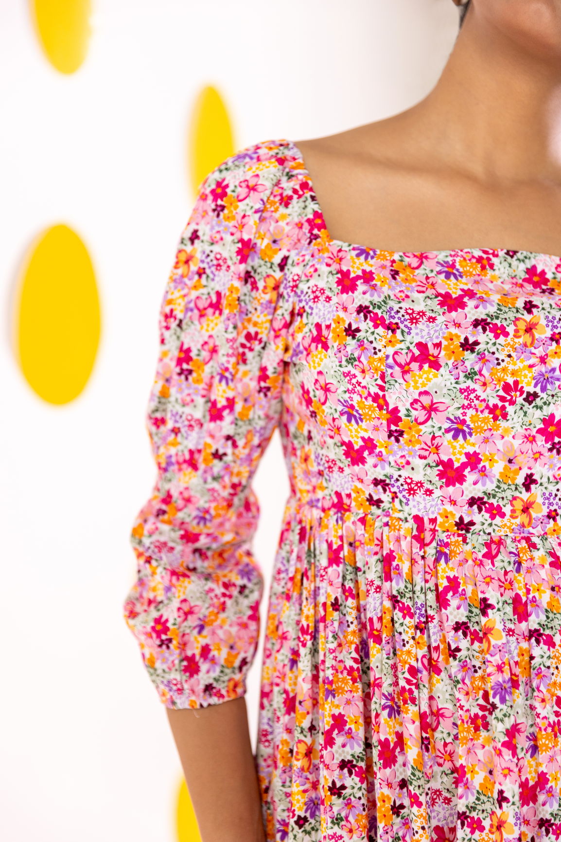 White floral cotton maxi dress with vibrant pink and orange flowers.