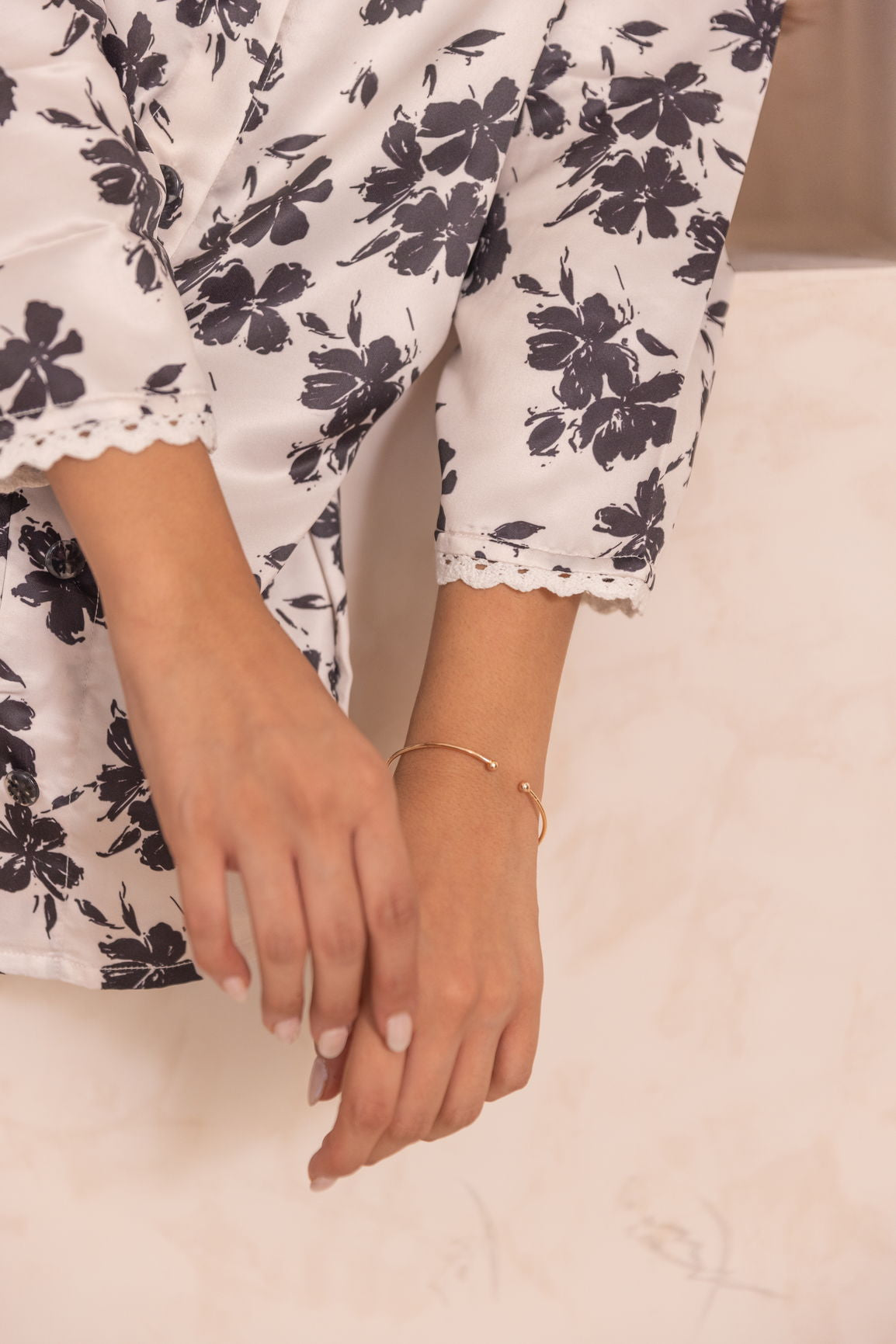 White floral satin co-ord outfit with elegant lace details and jewelry.
