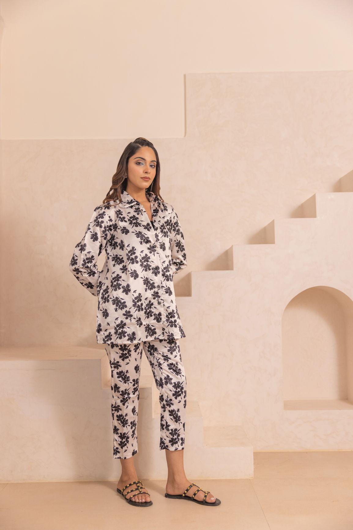 White floral satin co-ord set displayed on model in chic setting.