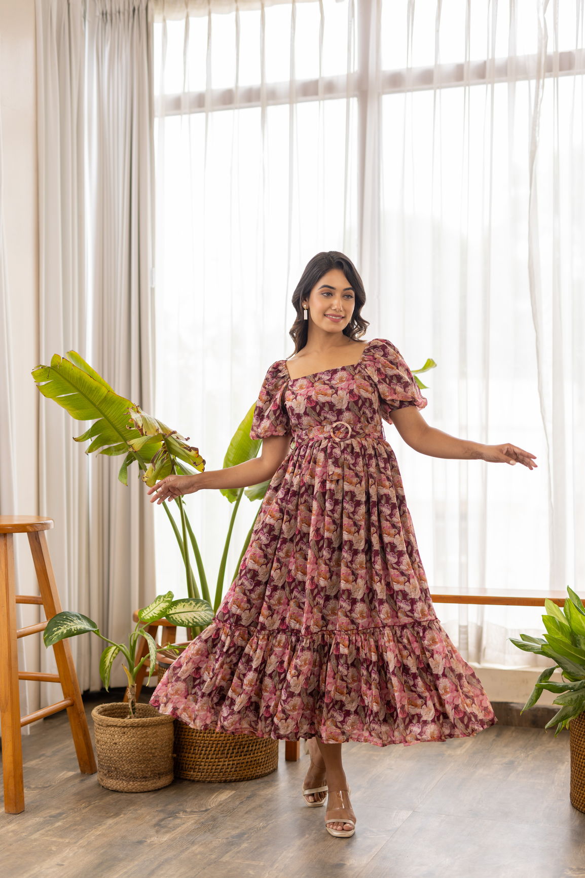 Stylish woman wearing wine floral belted maxi dress indoors.